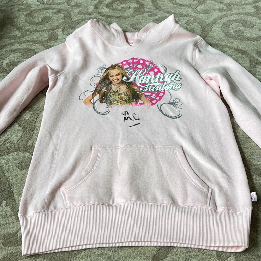 Miley Cyrus sweatshirt signed by Kevin Jonas on back and Mikey on front